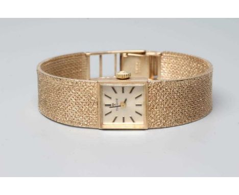 A LADY'S 9CT GOLD TISSOT WRISTWATCH, the square champagne dial with applied metal batons, the seventeen jewel movement number