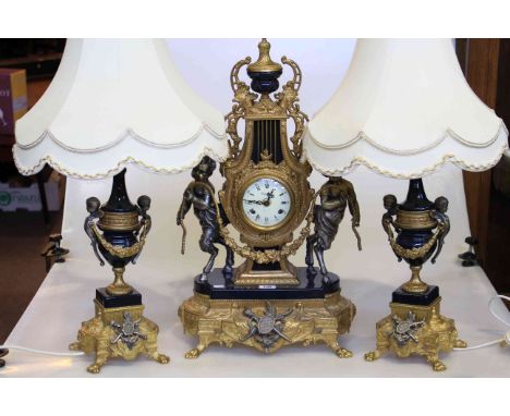 Highly ornate gilt cherub mantel clock together with pair table lamps