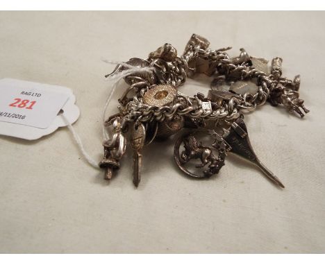 A silver charm bracelet having larger charms to include teapot, Concorde, spinner etc  95.4 grms