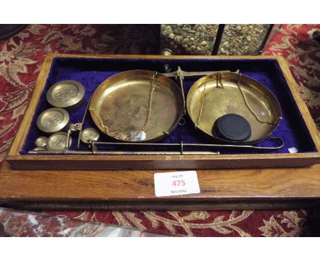 A set of scales and weights in fitted mahogany drawer-style case