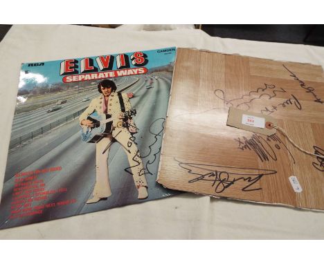 One record sleeve signed by Noel Gallagher and a floor tile signed by the group