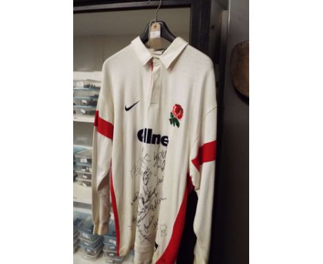 A signed England International Rugby shirt including Mike Catt, Neil Black, Martin Johnson, Lawrence Dallaglio, Johnny Wilkin