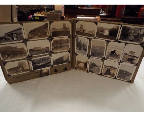A vintage photograph album with a selection of assorted photographs to include scenic, architectural etc 