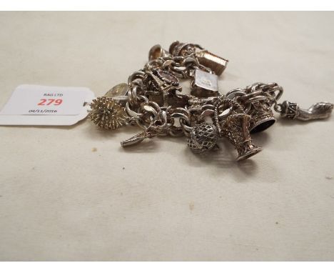 A silver charm bracelet having large size charms to include animal hoof, engagement hands, opening teapot, lobster pot etc  1