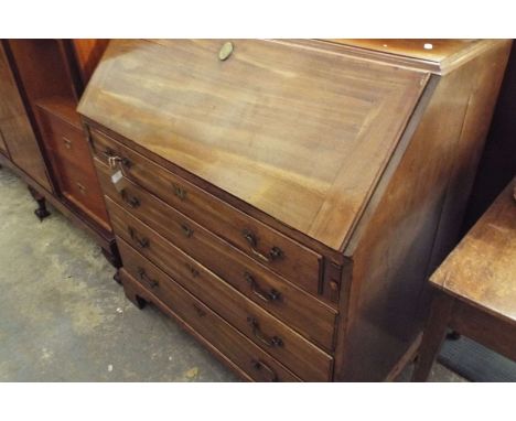 A Georgian mahogany bureau the fall flap enclosing inner compartments above four long graduating drawers, resting on bracket 