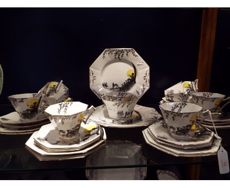 An early 1930s Melba China part tea service in octagonal form with design showing Pan playing to prancing fauna, in black and