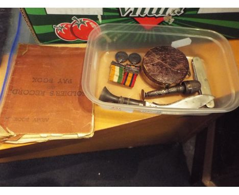 A brass mounted compass having fitted leather case, sewing case, a miniature kukri, penknife and two miniature medals; King's