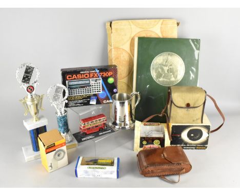 A Collection of Various Items to Comprise The Reader's Digest World Atlas, Trophies, Casio FX-730P Calculator, Diecast Model,
