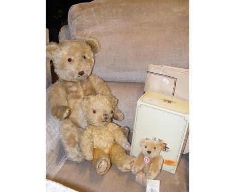 A Steiff miniature bear, tag to ear, and with original box and bag, together with two antique straw bears 