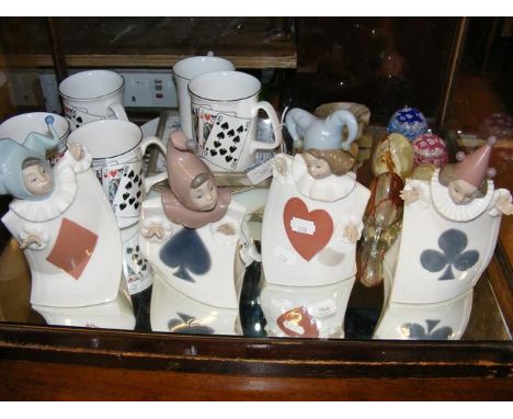 Four Nao playing card figurines, together with a pair of Caithness 'baby' paperweights, etc.  