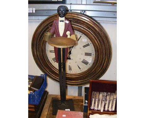 An oversized wall clock, together with novelty match striker 