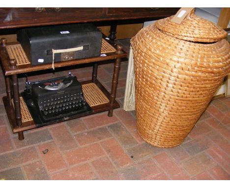 An Ali Baba laundry basket, vintage Imperial typewriter and a two tier occasional table 