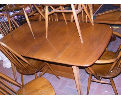 A vintage mid century Ercol extending dining table with eight 'Quaker' chairs (Four are carvers)  CONDITION REPORT Extended l