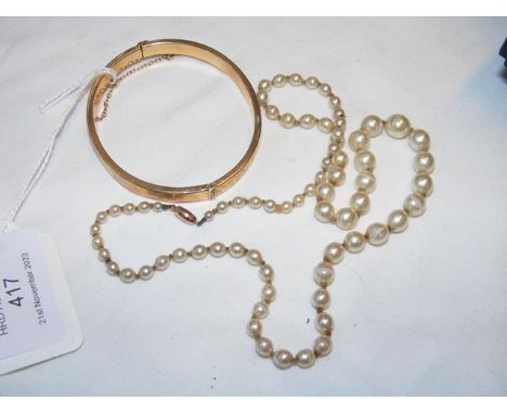 A 9ct gold bangle together with a pearl necklaceCONDITION REPORT.