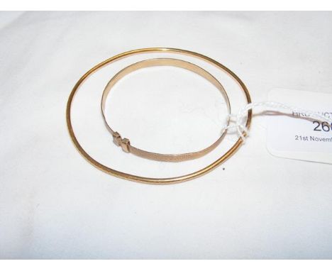A gold bangle and one other