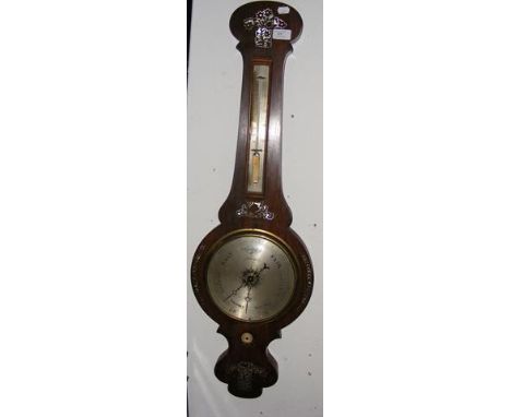 A wall barometer and thermometer 