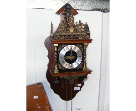 A reproduction wall clock with exposed bell to top 