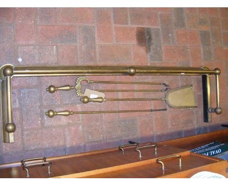 A brass fire surround and fire companion tools 