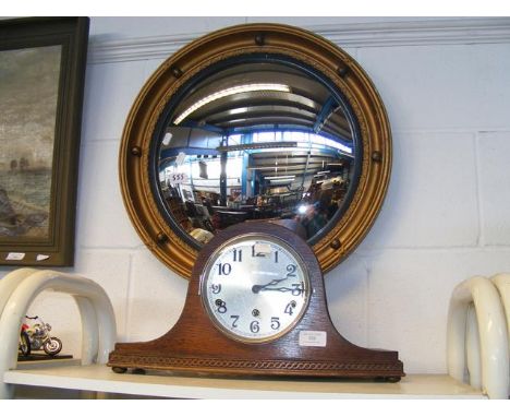 A circular wall mirror, together with 'Nelson's hat' oak cased mantel clock 