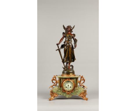 A green marble mantel clock with zamac sculpture "la Gloire". France, late 19th century.H.: 70 cm.