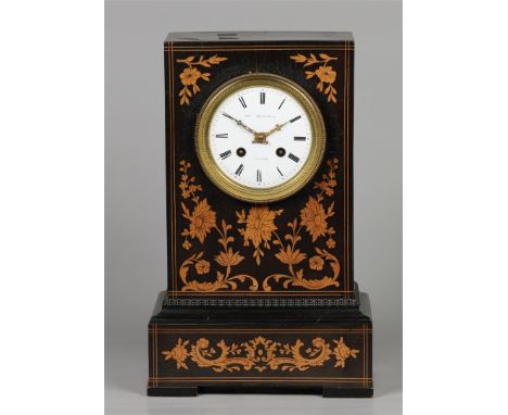 A mahogany veneered mantel clock with fruit wood inlay, enamel dial with Roman numerals. string clock. France, 19th century.H