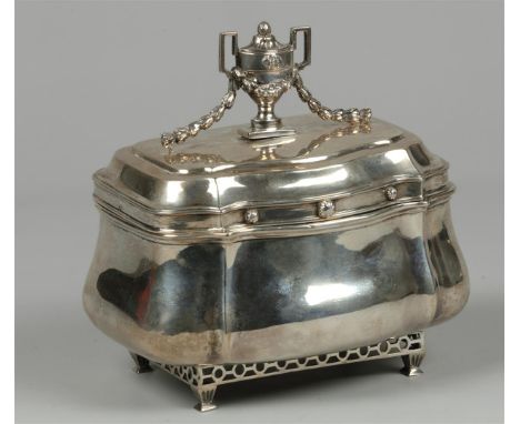 An 18th century bombarded silver tea caddy resting on trellis and fluted legs. On the lid a classicist vase with garland. Mar