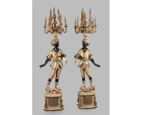A set of wooden polychrome blackamoor statues with lamp. 2nd half of the 20th century.H.: 215 cm.
