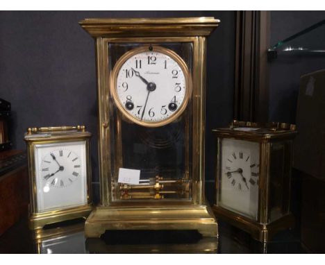 A gilt brass mantel clock by Ansonia Clock Co., New York, with bevelled glass sides and compensating pendulum; together with 