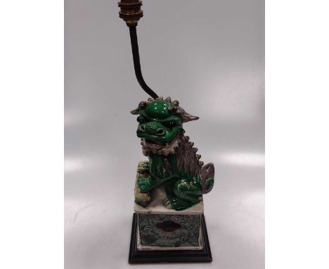 A Chinese famille verte porcelain fo dog figure, late Qing Dynasty, as a lamp stand, the female of dog with pup, 31 cm highCo