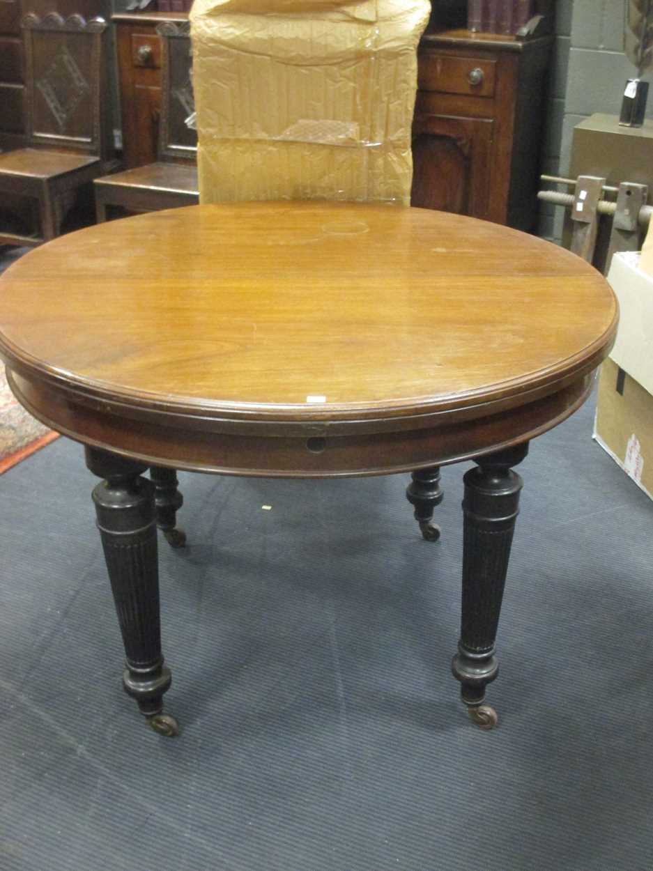 A late 19th century extending dining table with additional ...