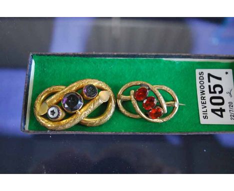 2 VICTORIAN YELLOW METAL KNOT BROOCHES, 1 SET WITH 3 AMETHYST COLOURED STONES, THE OTHER 3 RUBY COLOURED 