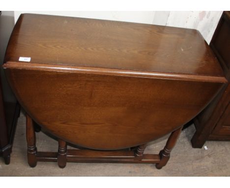 A 20th century oak gateleg dining table together with a set of four ladder back dining chairs and a dresser