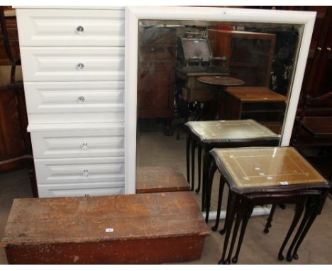 A large white painted wall mirror, together with a nest of tables and a pine trunk