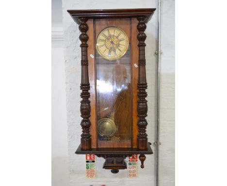 Vienna style wall clock, walnut and stained wood case, circular dial, movement striking on a gong, approximately 104cm.