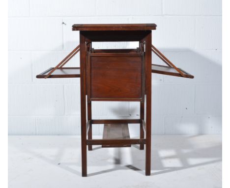 Edwardian walnut games table, rectangular foldover top, reeded legs joined by a shelf, and fitted with sliding trays, the top