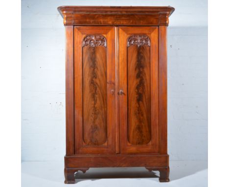 Continental mahogany armoire, probably Dutch, mid 19th Century, moulded cornice with concealed drawer, panelled doors, ogee b