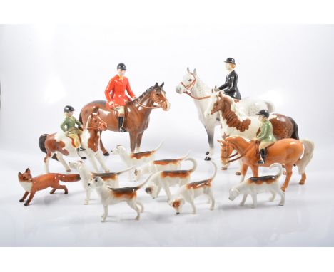 Beswick hunting group, to include Huntsman and Huntswoman, two pony club models. seven hounds, fox and piebald pony, (13)