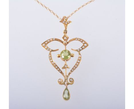An Edwardian pendant and chain, a circular peridot milgrain set in a yellow metal frame stamped 9ct and set with seed pearls 