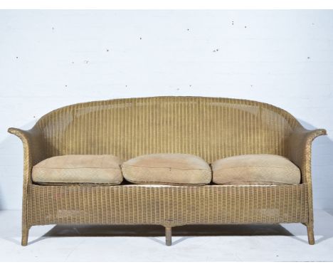 Lloyd Loom three-seat conservatory sofa, length 183cm; and a LLoyd Loom table. (2)