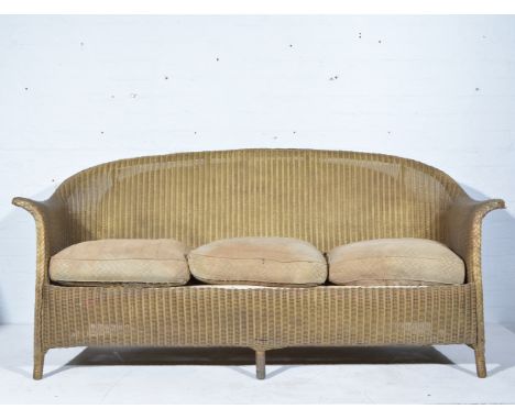 Lloyd Loom three-seat conservatory sofa, length 183cm; and a LLoyd Loom table. (2)