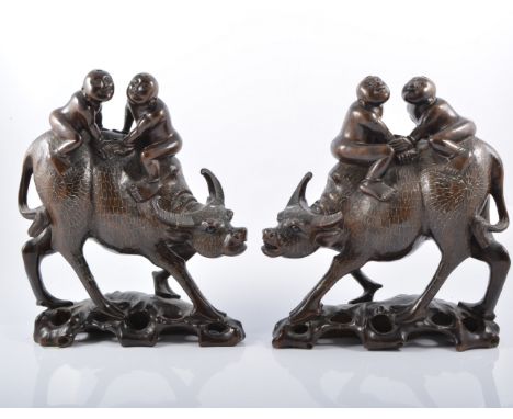 Pair of Chinese rosewood water buffalo with silver wire inlay, 29cm high.