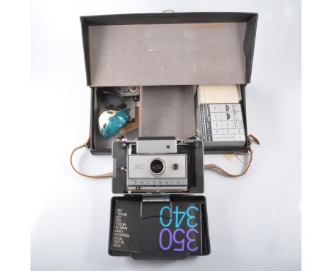 Polaroid 350 Land camera, with branded carry case, flash unit, instruction booklets, kits and accessories.