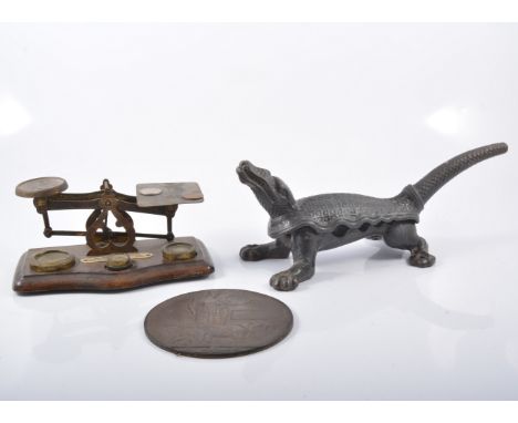 Cast metal nut-cracker in the shape of a crocodile, pair of brass candlesticks, pair of balance scales, WW1 death penny "Fran