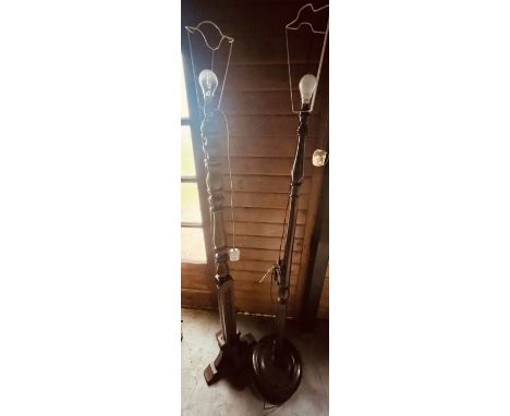 A 20th century oak standing lamp; another mahogany standing lamp similar (2)