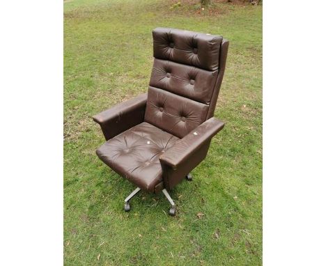 A brown leather vintage executive swivel armchair, note one button missing from seat.