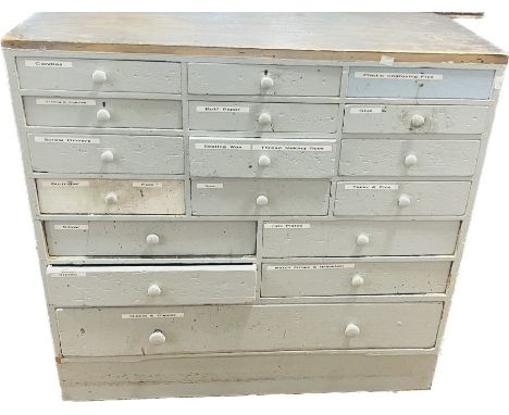 An early 20th century painted pine watchmakers chest of drawers, rectangular shaped, an arrangement of 12 short drawers on tw