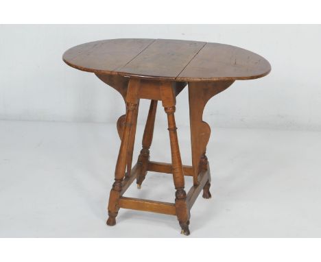 American Colonial tiger and curly maple small drop leaf table,  early 19th Century, the oval top with two fall leaves, raised