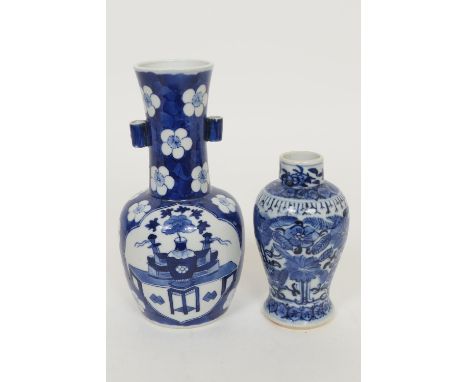 Chinese blue and white bottle vase, late 19th Century, decorated with panels featuring a table and objects against a ground o