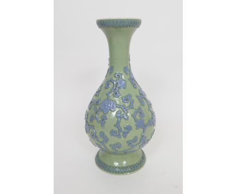 Chinese Republic carved celadon vase, late 20th Century, trumpet baluster form carved with peony scrolls in light blue agains