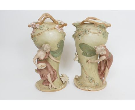 Pair of Royal Dux Art Nouveau style figural vases, each modelled with a maiden feeding doves, in buff and pink colours highli